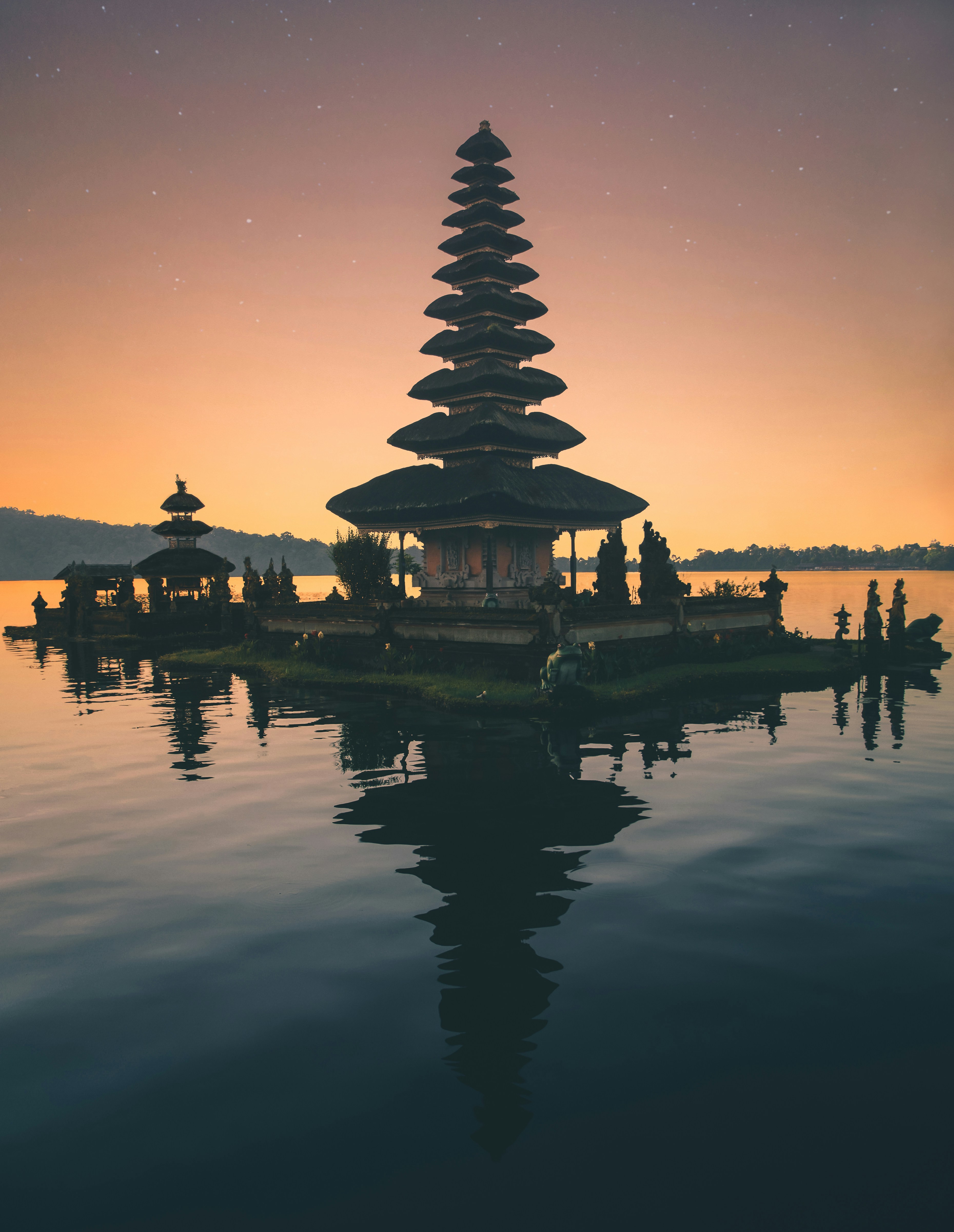 Ulun Danu Temple at sunset, reflected in a still mountain lake
